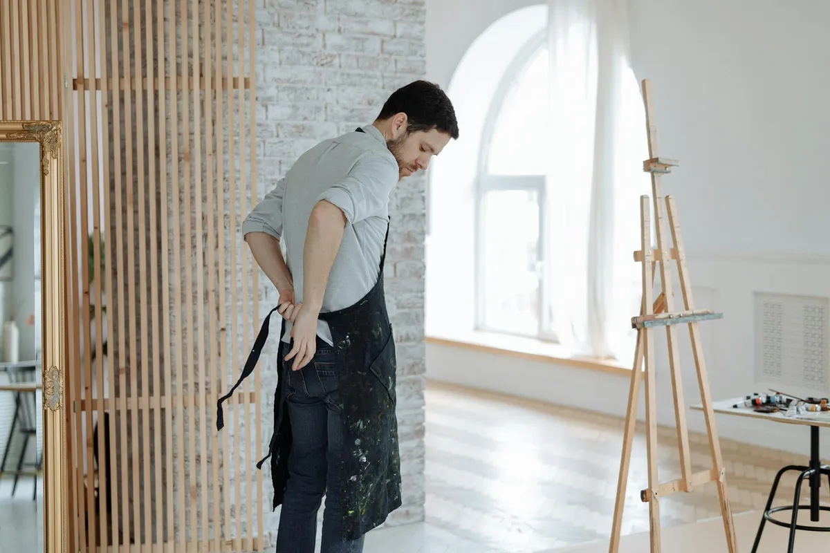 A painter at work in a sunlit studio